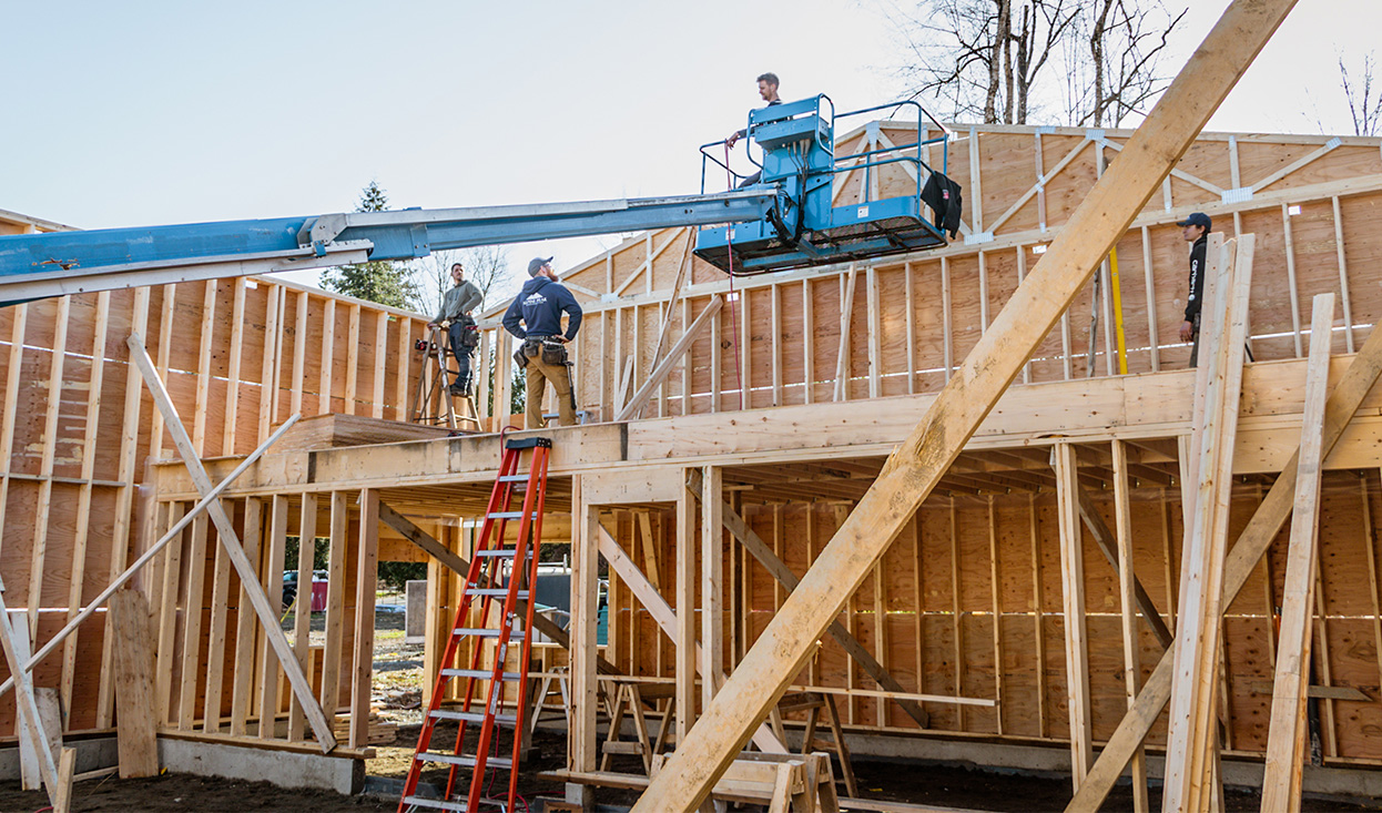 Installing trusses on a home with a crane